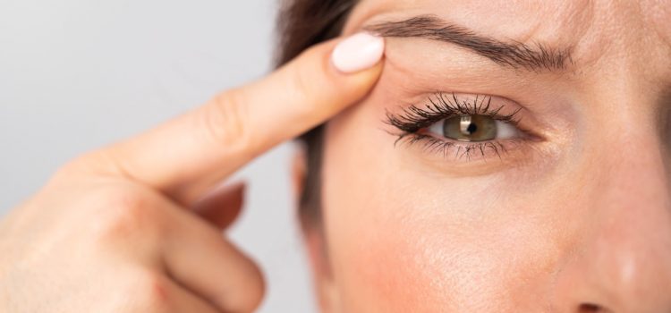 woman lifting eyelid like blepharoplasty